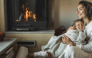 Mom and daughter by the fireplace-8 Reasons to Hire A Chimney Sweep Now-The Fire Place-Louisville KY-1100x495jpg